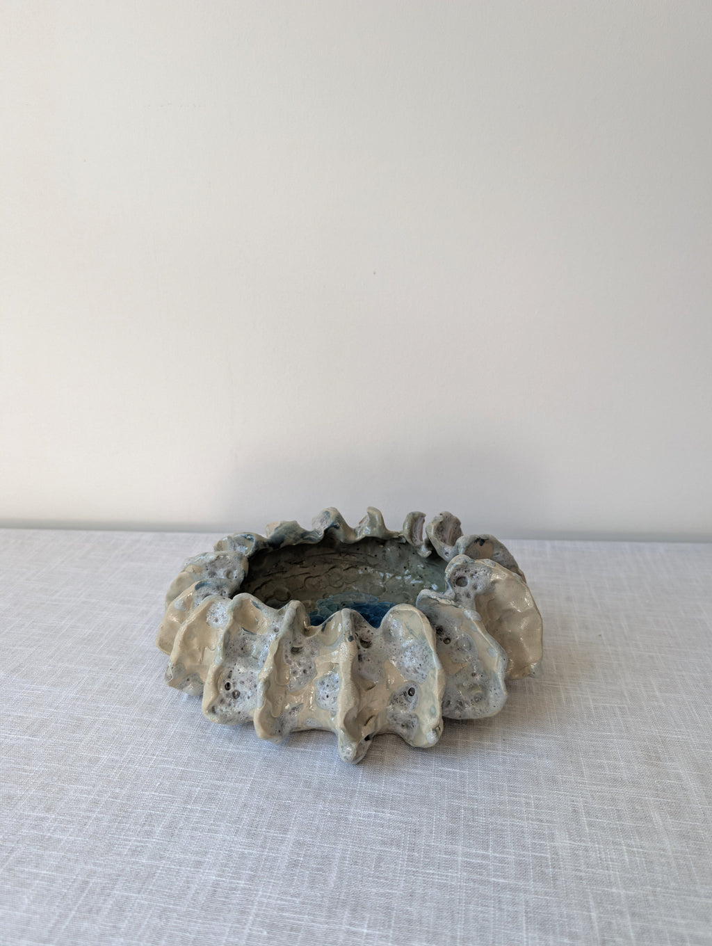 Sculptural Ceramic Bowl with Organic Rim and Blue Glaze, photograph 1