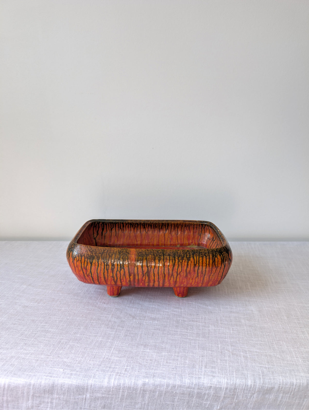 Orange-Red Footed Ceramic Tray with Black Drip Glaze, photograph 1